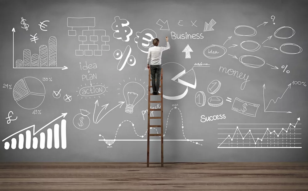 showing man writing on black board