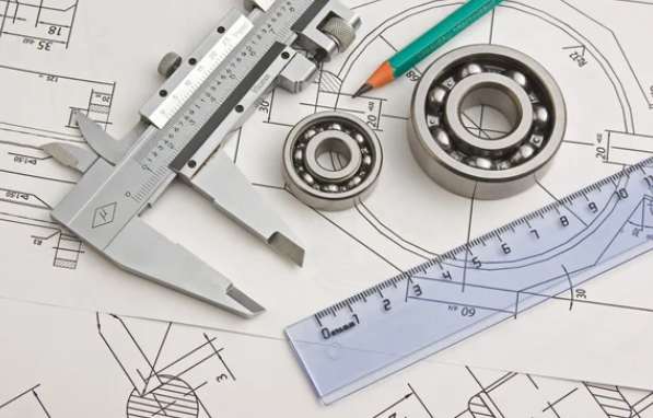 image showing caliper and rulers with a bearing and a pencil